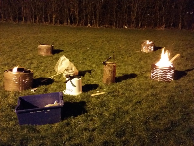 A campfire with some scouts equipment